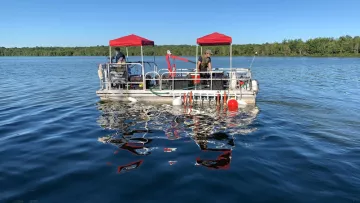 Pontoon boat on a lake, Healthy Water Solutions
