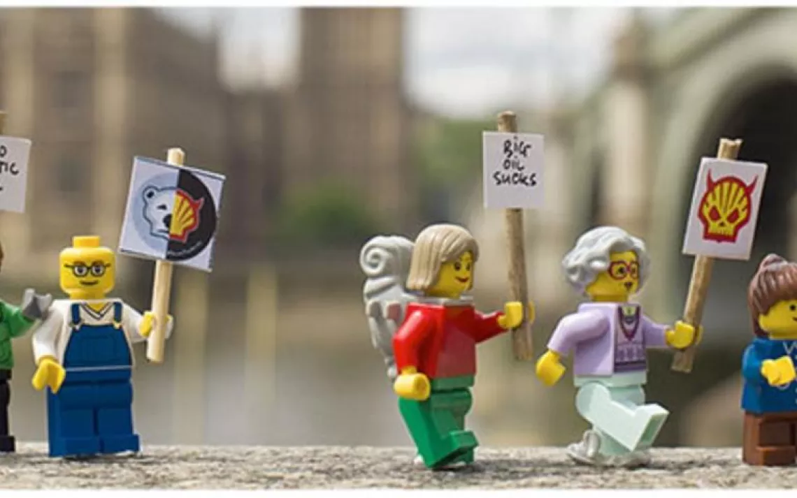 lego characters holding signs