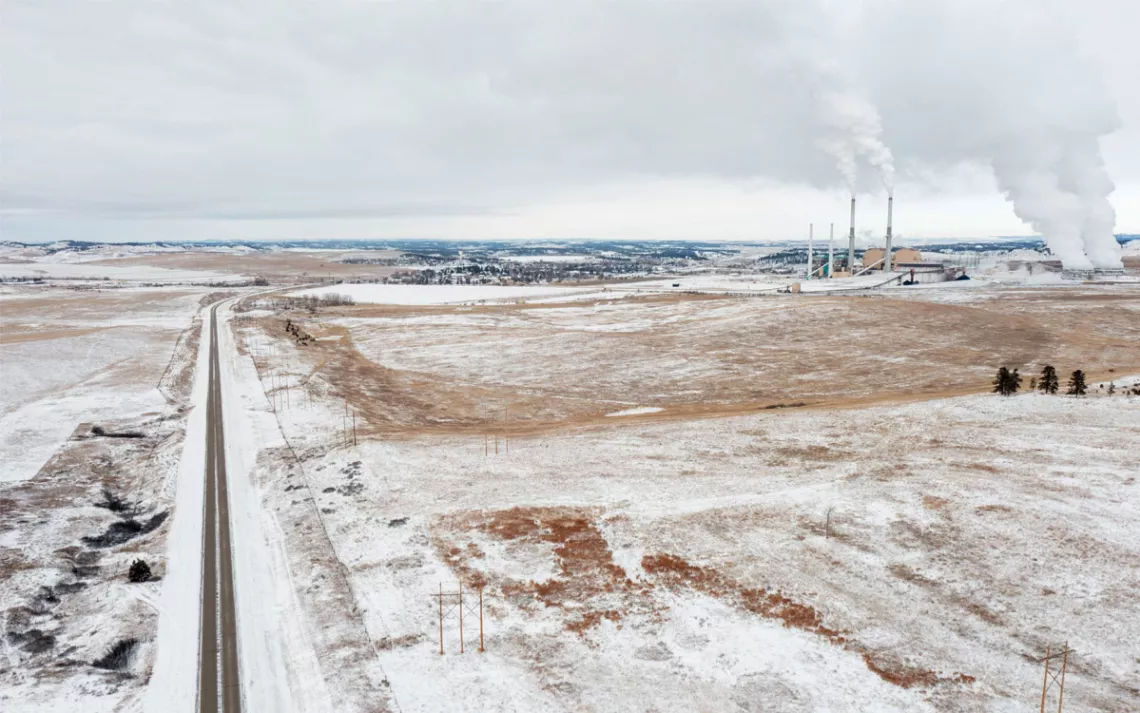 The Colstrip power plant sits in an area of snow-covered open land