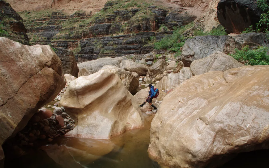 Travis Moles navigates boulders in Kanab Creek, near Grand Canyon National Park.