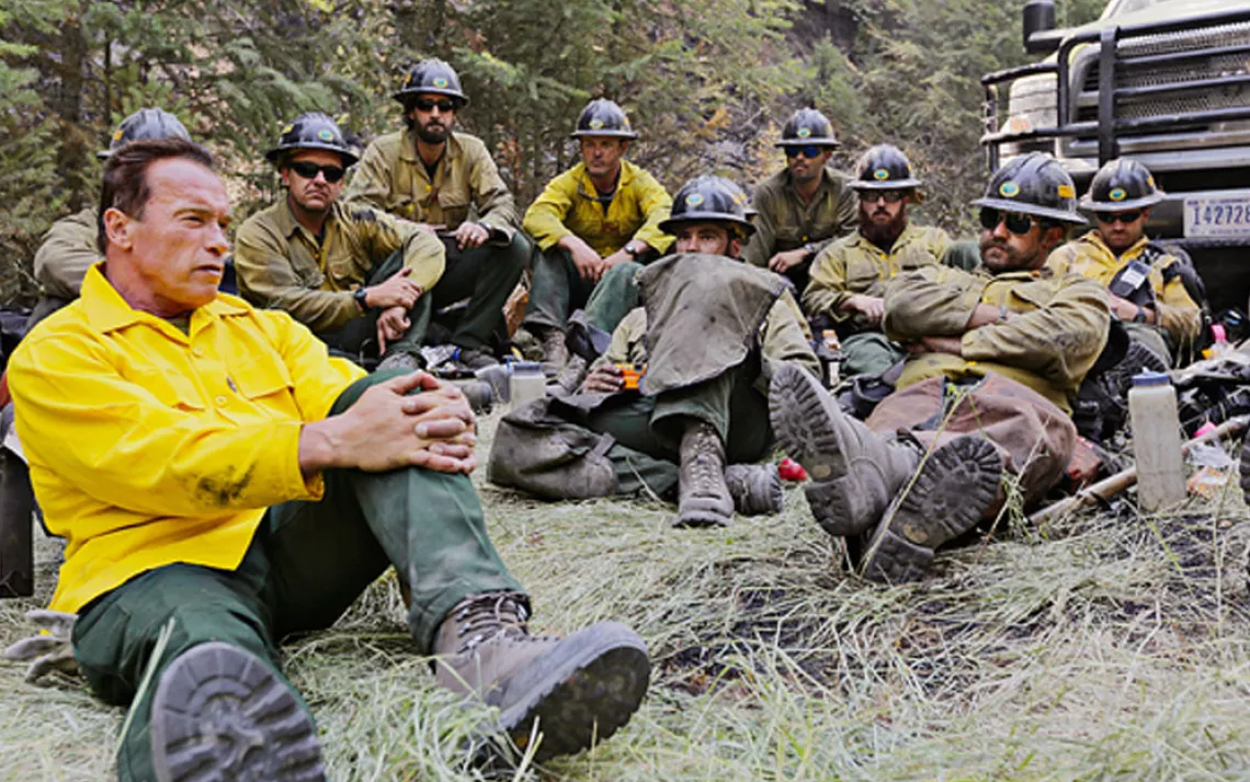 Arnold Schwarzenegger hangs out with firefighting "hotshots" in Years of Living Dangerously, a new series by David Gelber (top left) and Joel Bach (below).