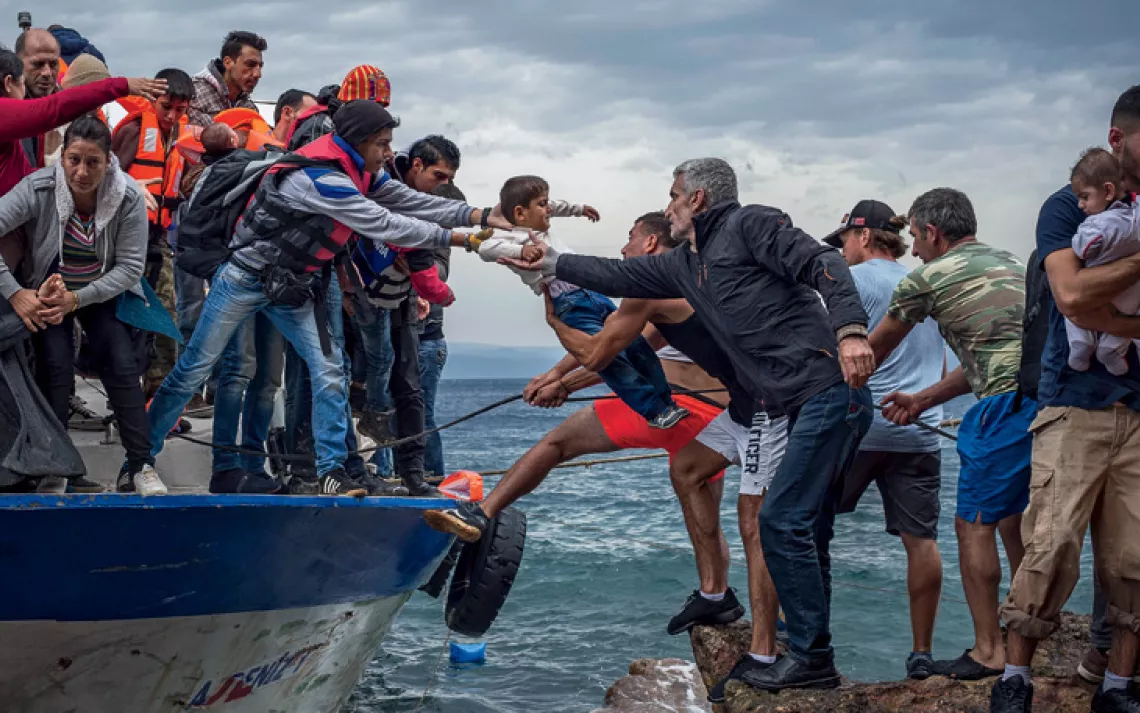 Migrants arrive at the Greek island of Lesbos after crossing the Aegean Sea from Turkey.