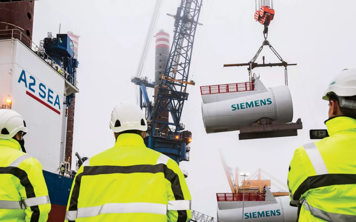 Giant 6-megawatt turbine nacelles move down Siemenss assembly line. The factory is powered by an on-site 1-megawatt turbine.