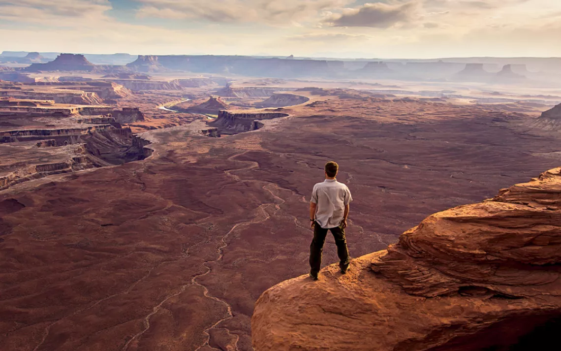 A man enjoys the view near Green River Overlook in Canyonlands National Park, Utah.