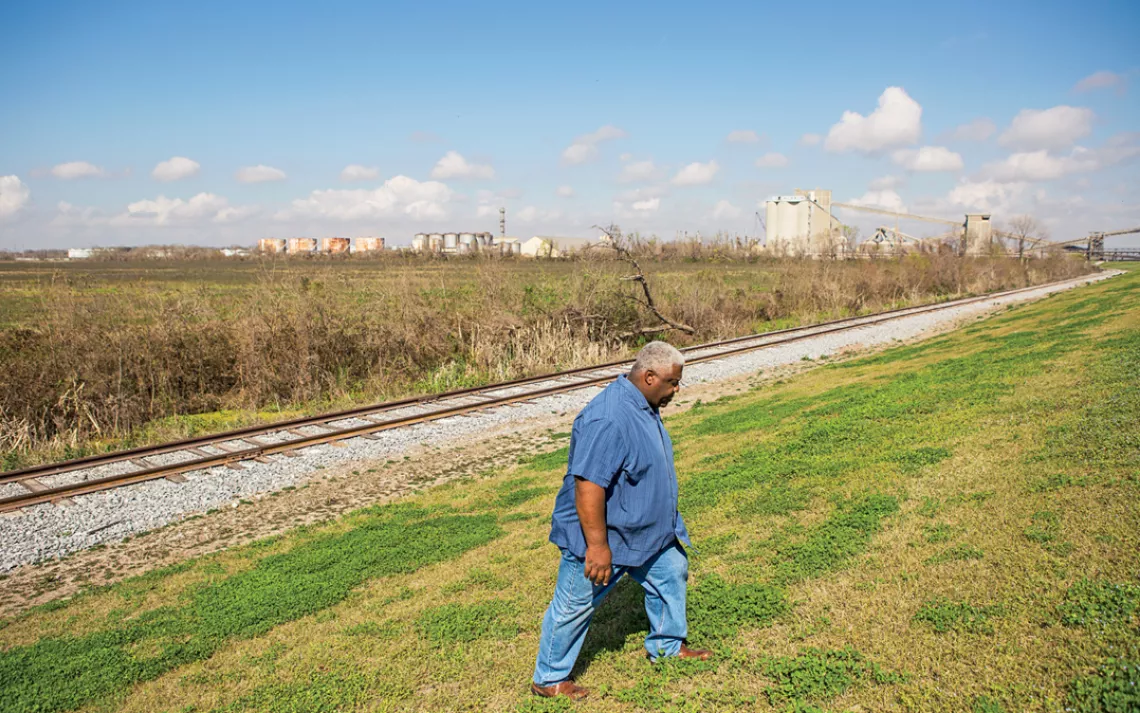 Wilkey Declouet walks by the levee near the proposed RAM coal terminal site, about a half mile away from Ironton, Louisiana.