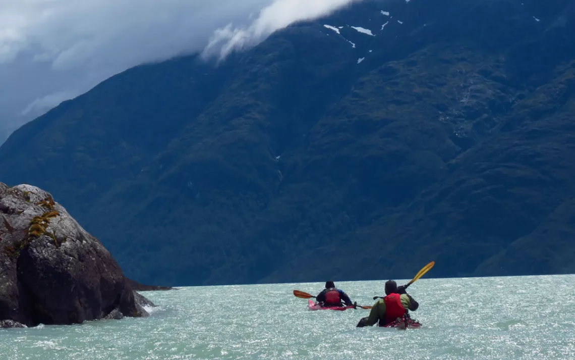 Roberto Haro Contreras and Lisa Gelczis paddle along the shoreline, against the headwind of the fjord.