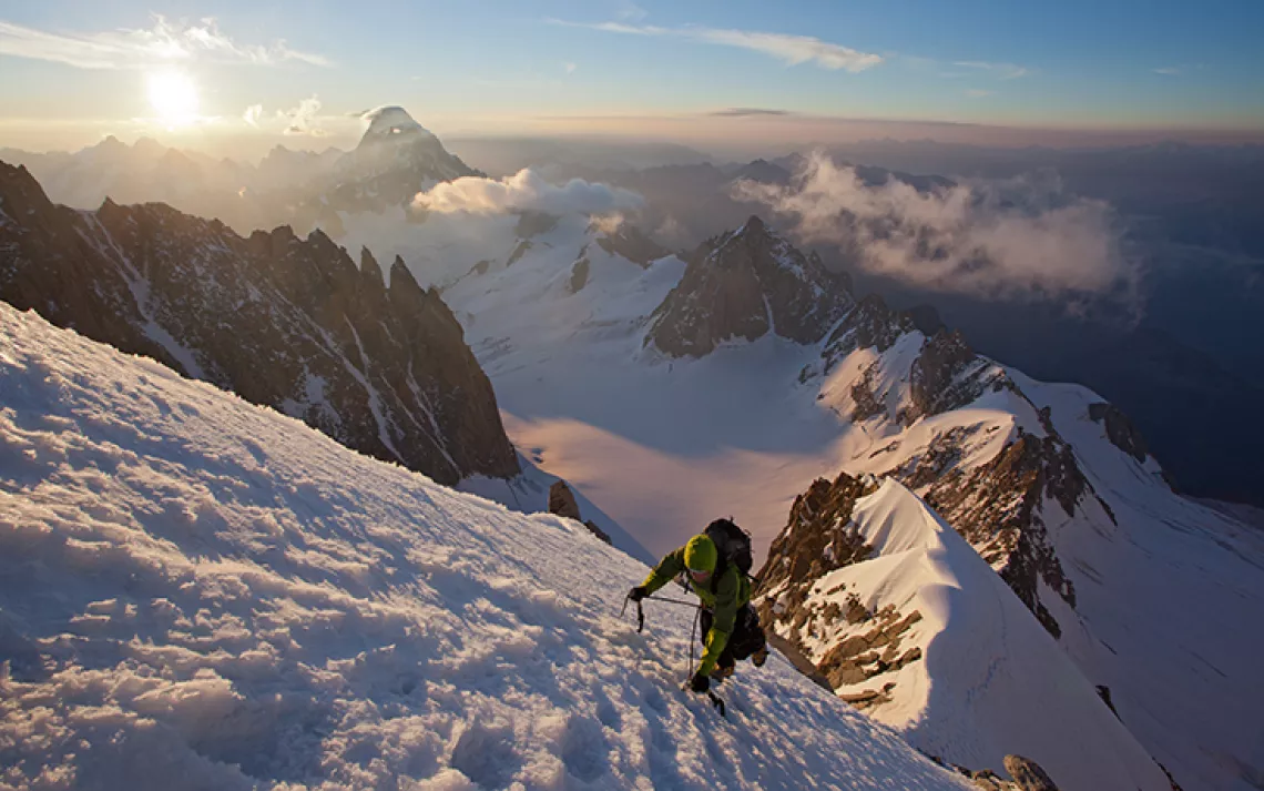 Ben Briggs racing up the Kuffner arête at sunrise. Photo by Jon Griffith in Alpine Exposures.