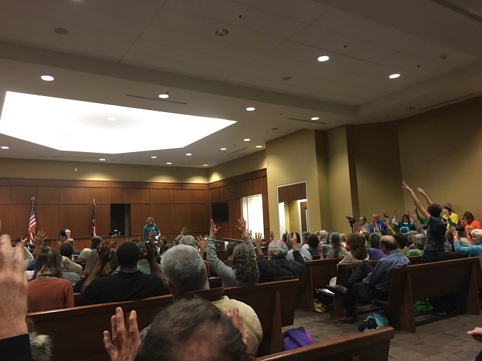Beyond Coal activists at last Tuesday&#039;s Duke Energy hearing wave their fingers in support of the opposition&#039;s testimony.