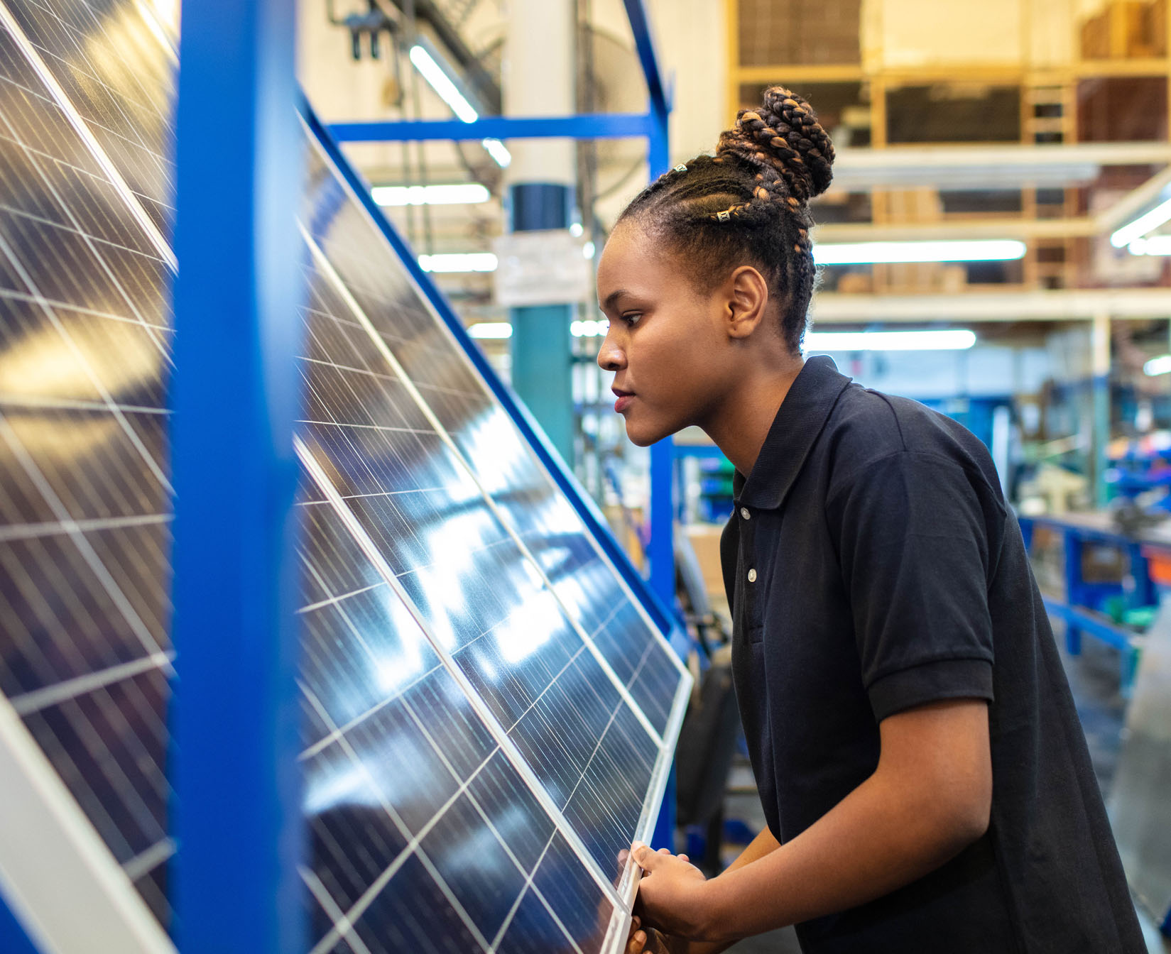 woman inspecting solar panels