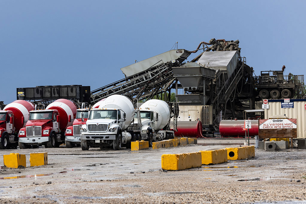 Cement trucks parked at a facility in Plaquemines Parish, Louisiana.