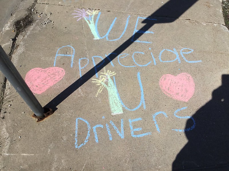 Sidewalk chalk that says "We appreciate U drivers!"