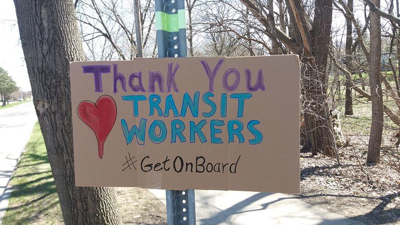 A sign that reads "Thank you transit workers #GetOnBoard"