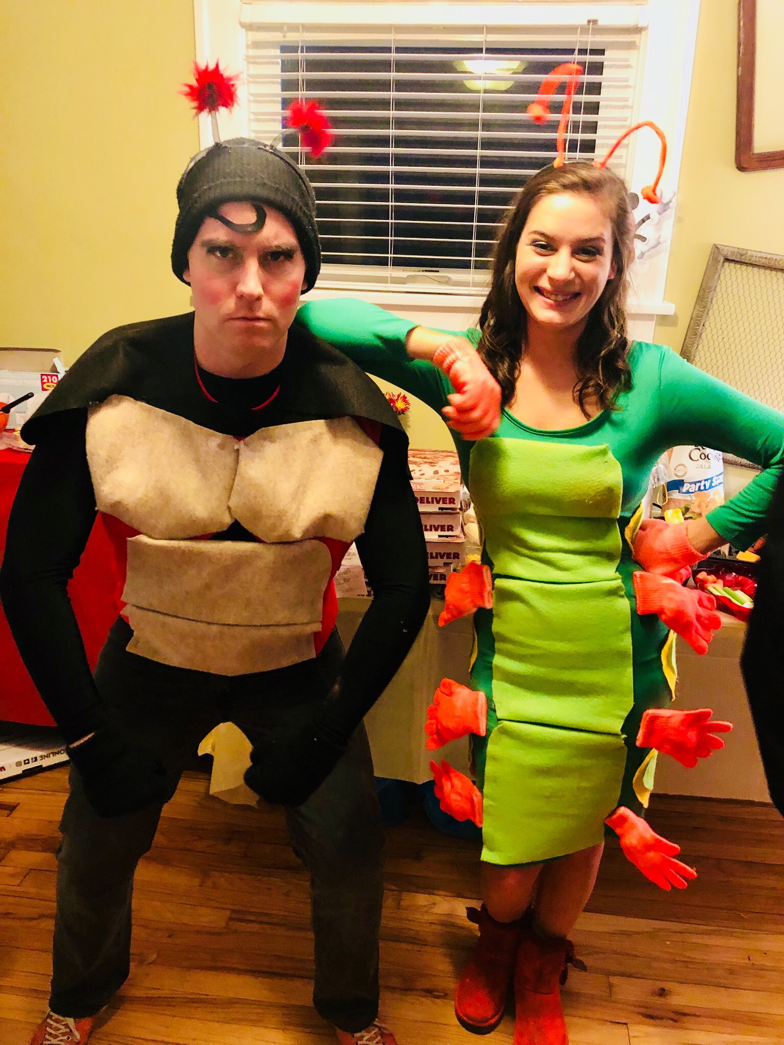 Male and female dressed in homemade bug costumes