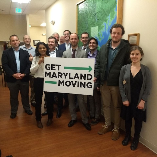 Group holding sign "Get Maryland Moving"