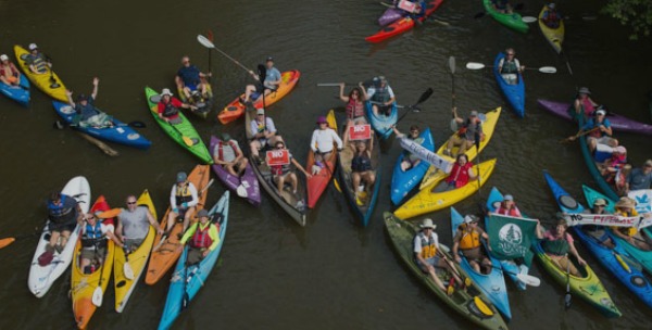 Kayakers gather on the Tar River to protest the Atlantic Coast Pipeline