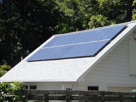 Building with solar panels on peaked roof