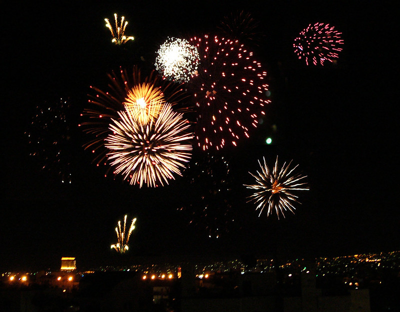 Fireworks over city lights
