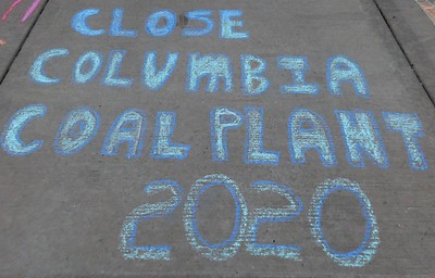 Sidewalk chalk that says "close columbia coal plant 2020"