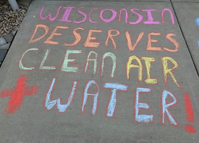 Sidewalk chalk that says 'Wisconsin deserves clean air" 