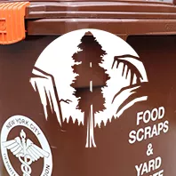 Sierra Club Logo over close up of brown NYC food recycling bin