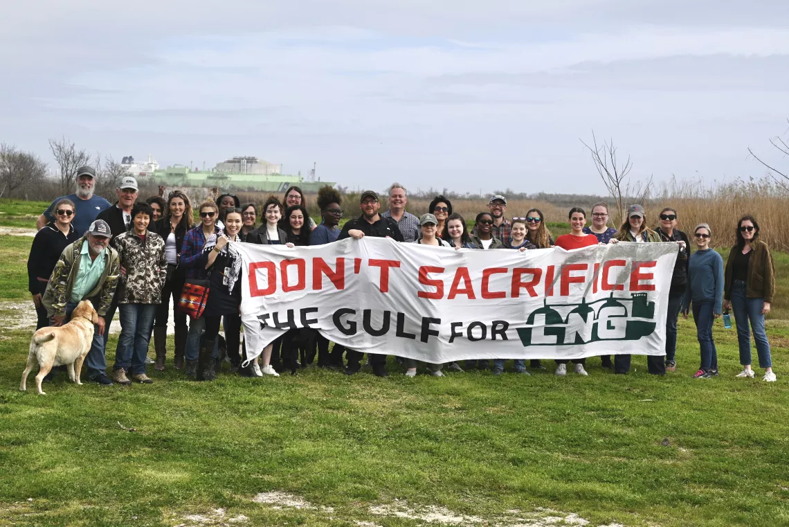 Activists pose with a banner "don't sacrifice the Gulf for LNG"