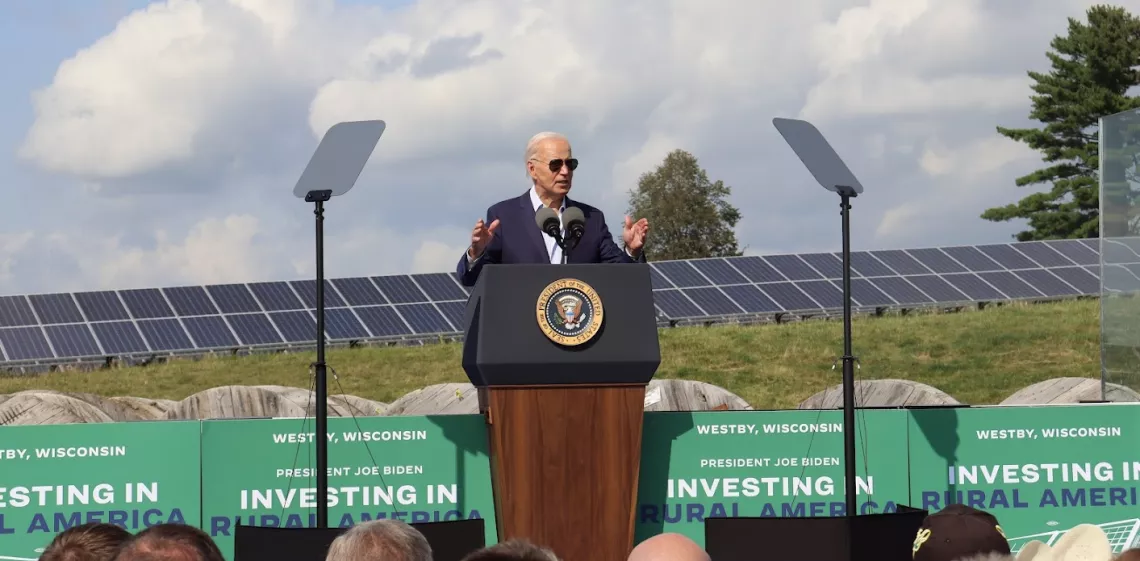 President Joe Biden standing in front of solar panels in Westby, WI