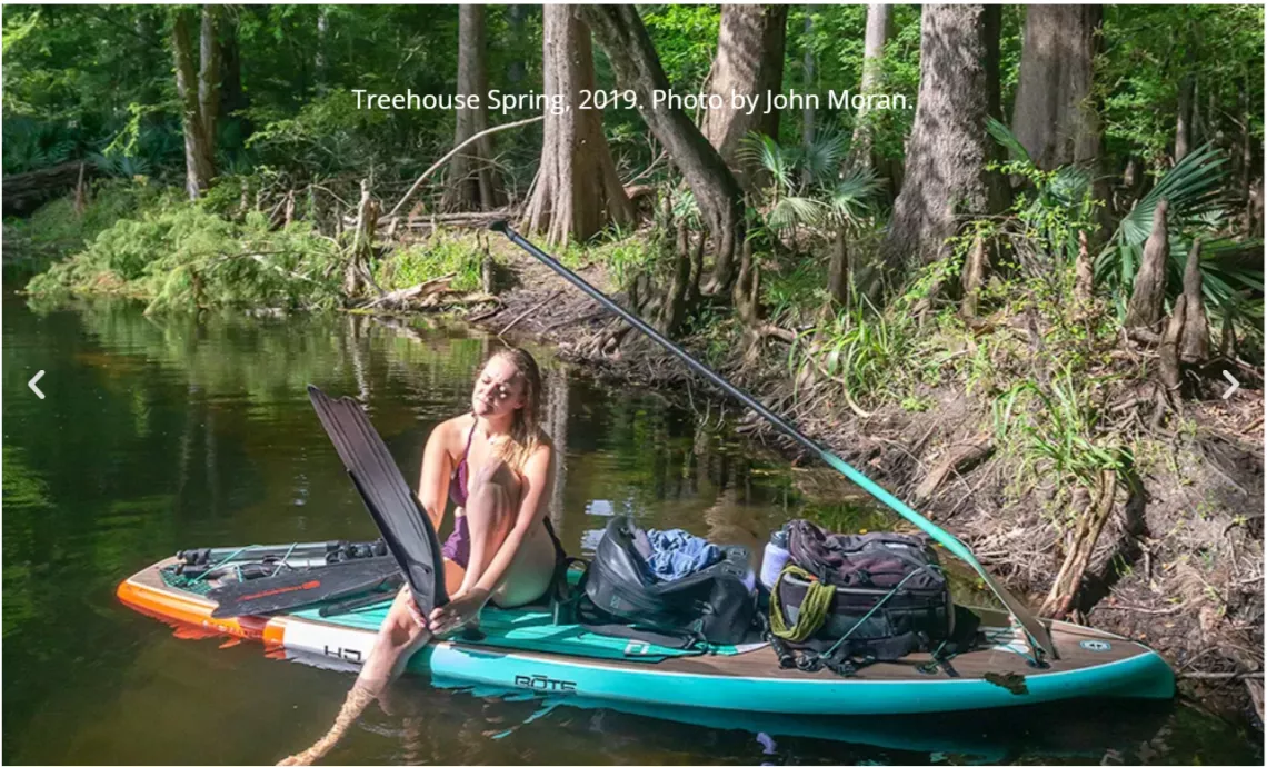 A snorkler prepares to get in the water at Treehouse Springs