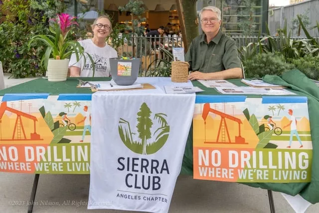 Two volunteers tabling an event for Sierra Club