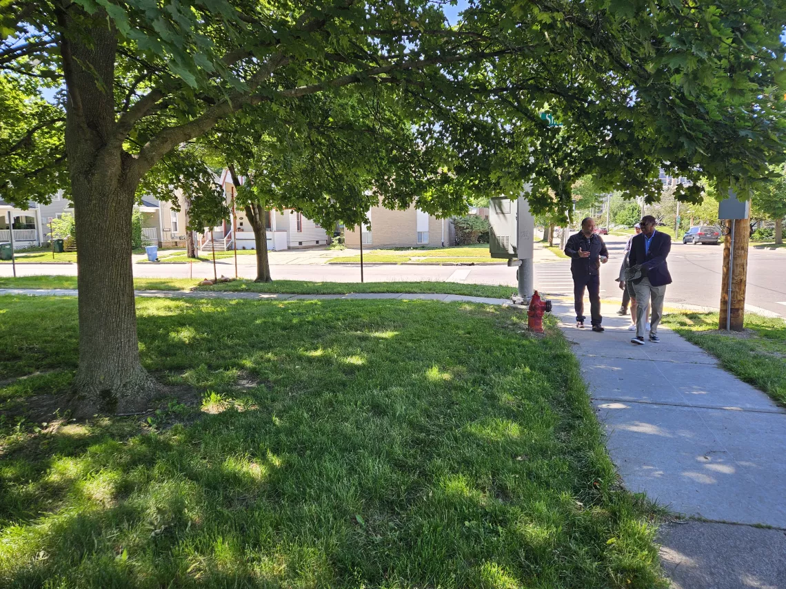 two men walk in a park