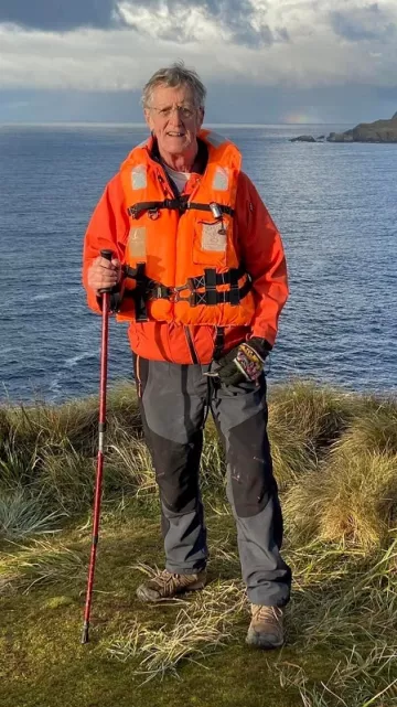 Pisgah Group Chair Jim Reynolds stands on a seaside cliff in Chile on his 70th birthday in 2023