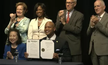 Maryland Governor Wes Moore and his cabinet pose and clap for executive order signing. 