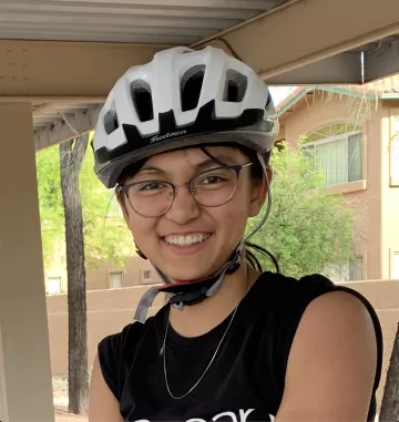 Lyla Yango smiling while wearing a white bike helmet