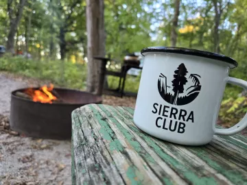 Sierra Club cup and campfire