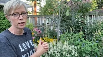 Speaker in front of vibrant garden