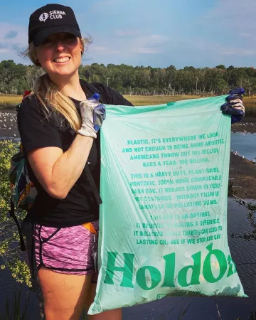 Amanda Voges holding beach clean up litter bag