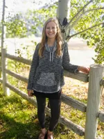 Picture of Jenna standing by a fence outside