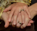 Hands of two women wearing wedding rings