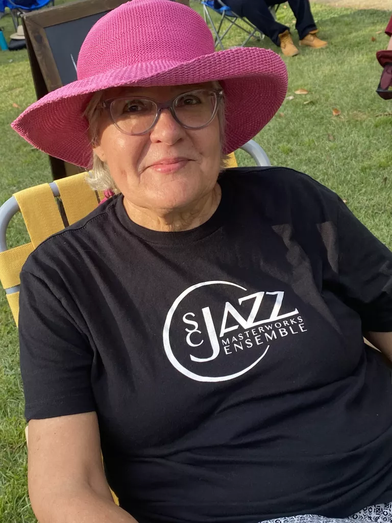 Elaine Cooper - Midlands Group - sitting in lawn chair, pink hat