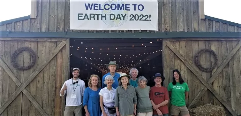 Members of the Cypress Group (NC Sierra Club) pose in front of a barn as they participate in a celebration of Earth Day 2022