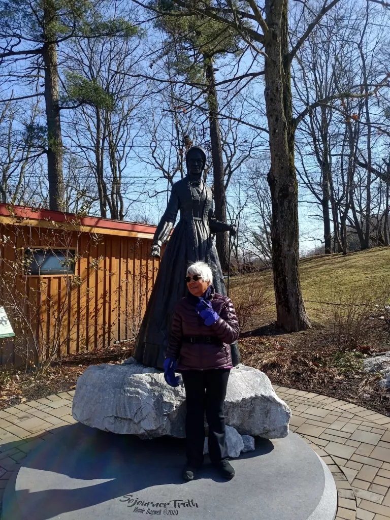 Before a statue of Sojourner Truth