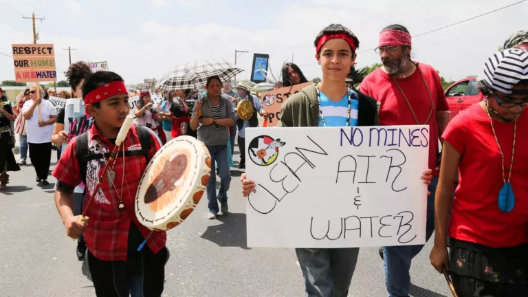 marching with sign for clean air and water