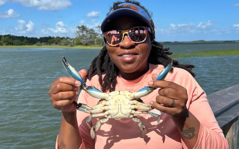 Tia Clark holds a blue crab. |