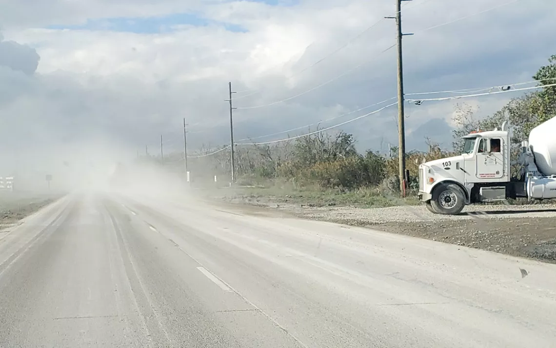 Dust obscures the highway near Venture Global's Plaquemines LNG construction site in November 2023.