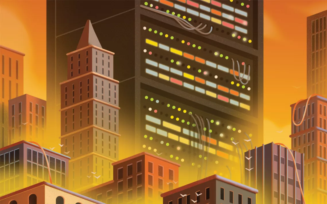 Illustration shows a skyscraper-size computer mainframe with wires coming out the back, next to other city buildings