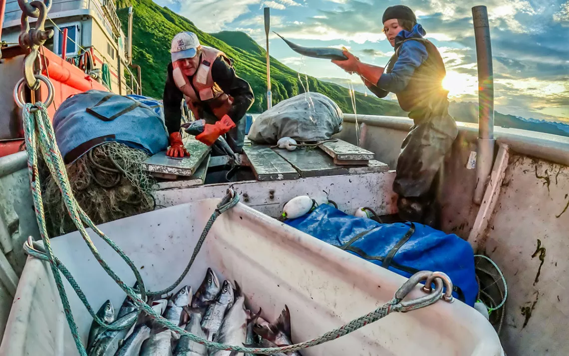 Author Dustin Solberg and his son harvest wild sockeye salmon every summer in Alaska’s Tuxedni Bay. They’re part of a community of commercial fishing families working from small boats in a fishery certified sustainable by the non-profit Marine Stewardship Council. | Photo by Hamish Laird