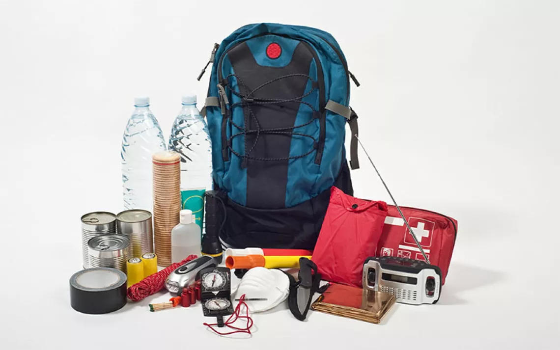 A go-bag with emergency items displayed outside it