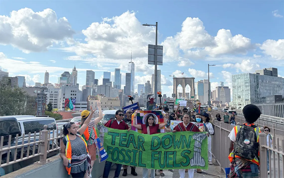 Xiye Bastida, a New York-based climate activist from the Otomi-Toltec Indigenous community in Mexico, marches down the Brooklyn Bridge alongside protesters. | Photo by Sara Hashemi