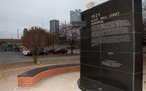 A memorial to Tulsa's Black Wall Street sits outside the Greenwood Cultural Center on the outskirts of downtown Tulsa