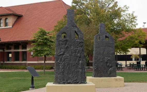 A portion of Preston Jackson's 2009 "Acts of Intolerance" statue in Springfield, Illinois' Union Square. The statue, in the form of two chimney columns that are all that remains from a burned-out building, commemorates the deadly Springfield race riot of 1908, in which white mobs attacked African-American residents, burned several homes, and lynched two black men.