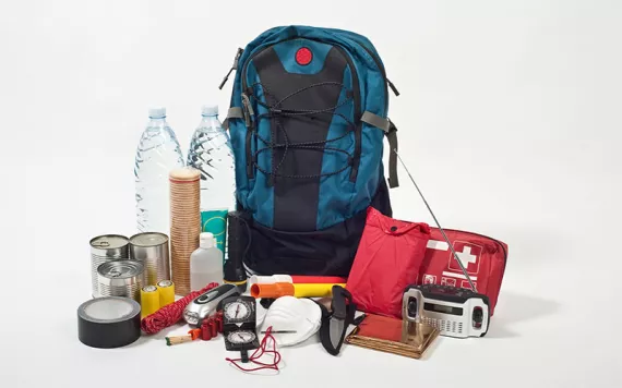 A go-bag with emergency items displayed outside it